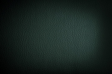 dark green leather background or texture with dark vignette bord