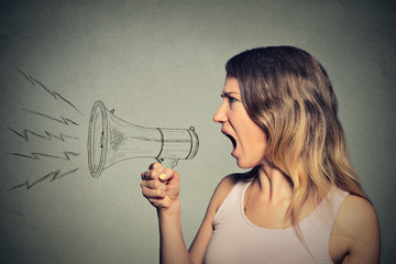 angry screaming young woman holding megaphone