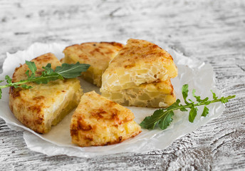 potato tortilla on a light wooden background