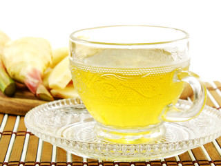 ginger drink and ginger root on wooden background