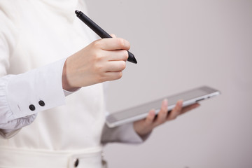 woman holding a tablet and stylus