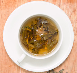 green tea with jasmine on a wooden background