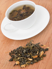 green tea with jasmine on a wooden background