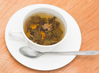 green tea with jasmine on a wooden background