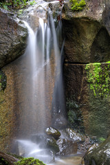 Fototapeta na wymiar Softness and peace of water falling over rocks.