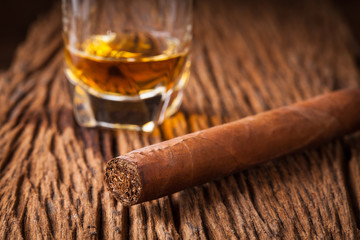 cigar and whisky on old wooden table