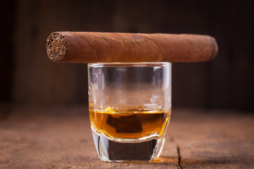 cigar and whisky on old wooden table