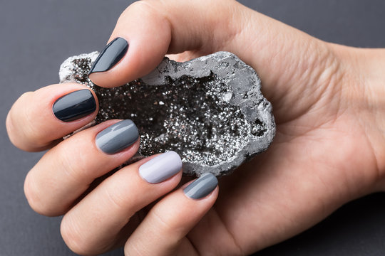 Female Hand With Textured Silver Mineral