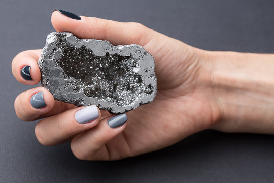 Female Hand With Textured Silver Mineral