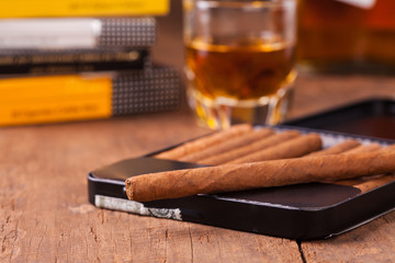 cigars and whisky on old wooden table