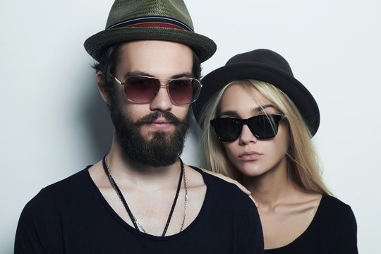 beautiful couple together.Bearded young man and girl in sunglasses