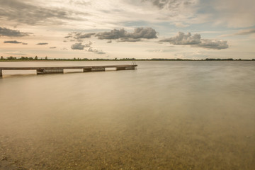 bridge in small lake long exposure