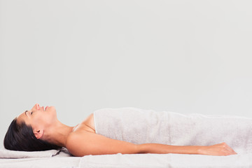 Obraz premium Happy woman lying on massage lounger