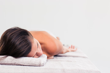 Obraz na płótnie Canvas Woman resting on massage lounger