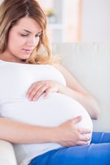 Pregnant woman relaxing on the couch