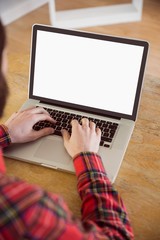 Hipster businessman working on his laptop