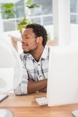 Young businessman sitting at his desk 