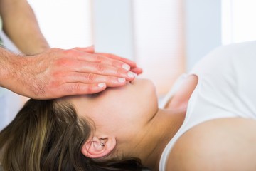 Close up view of relaxed pregnant woman getting reiki treatment