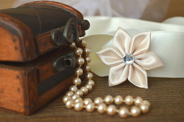 Wedding accessories concept. Kanzashi flower and pearls. Handmade fabric flower.