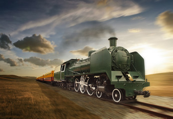 vintage green and yellow steam powered railway train moving