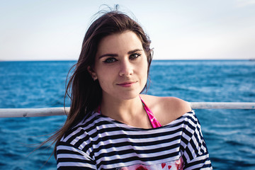 young beautiful female posing on a yacht in a sea