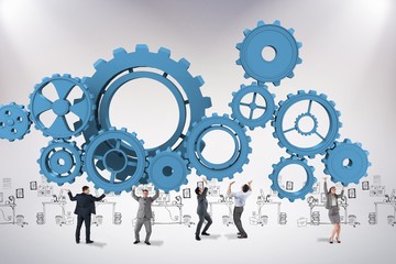 Composite image of business team supporting engine