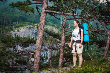 Caucasian hiker woman on trek in mountains with backpack living a healthy active lifestyle. Hiker girl on nature landscape hike in Crimea.