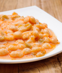 homemade stew of white beans on wood