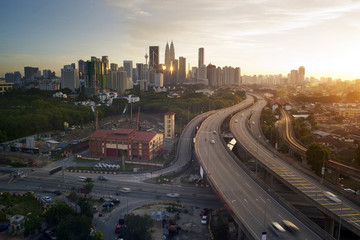 Obraz na płótnie Canvas Dramatic scenery of elevated highway heading towards Kuala Lumpur city centre during sunset.