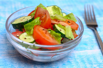 Fresh salad with tomatoes, cucumbers and lettuce