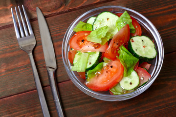 Fresh salad with tomatoes, cucumbers and lettuce
