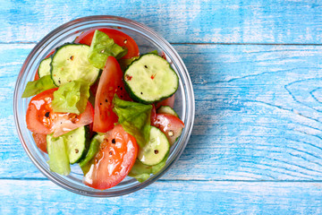 Fresh salad with tomatoes, cucumbers and lettuce
