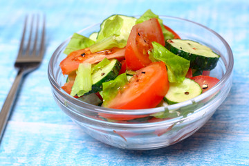 Fresh salad with tomatoes, cucumbers and lettuce