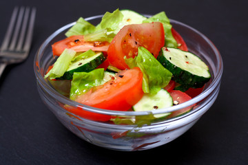 Fresh salad with tomatoes, cucumbers and lettuce