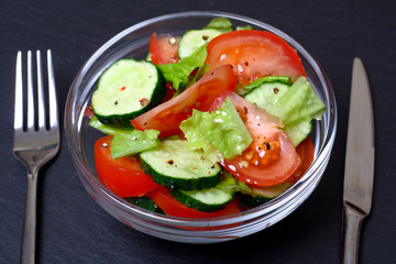 Fresh salad with tomatoes, cucumbers and lettuce