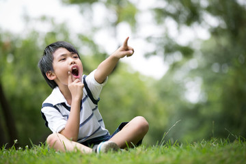 Portrait of a little asian boy in the park