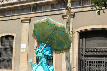Straßenkünstlerin mit Sonnenschirm in der Altstadt von Barcelona