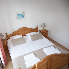 Fototapeta na wymiar Interior of arranged double bed in a room