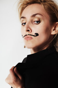 young woman with painted mustache wearing jacket