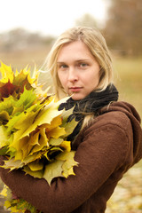 Woman with autumn wreath outdoors