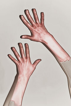 Male hands painted in red paint