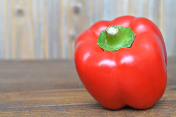 Red bell pepper on wooden background