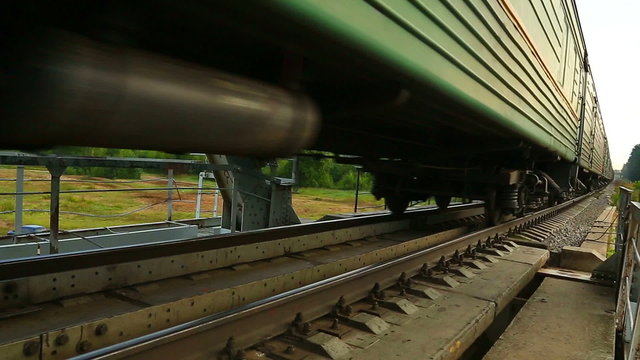 passenger train rides on the railway bridge, next to the camera
