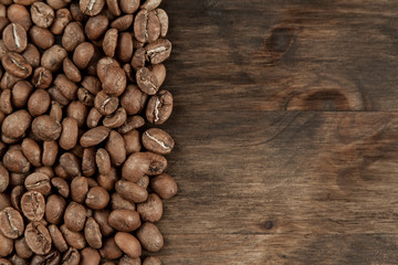Background coffee. Roasted beans on old wooden background