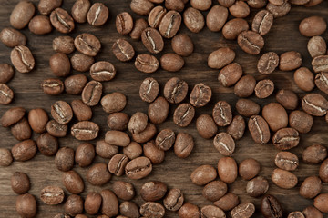 Background coffee. Roasted beans on old wooden background