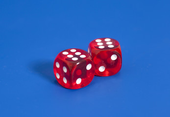Red dices on blue background