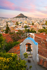 View of Lycabettus hill and a small Greek orthodox church in Anafiotika, Athens.