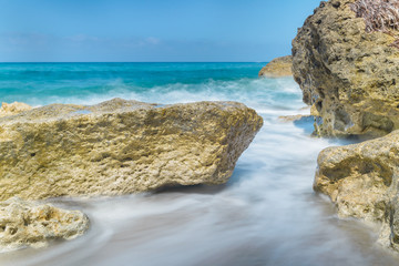 Fototapeta na wymiar Waves crashing against the rocks at the beach on the Mediterranean island of Cyprus.