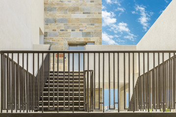 Railing and stone facade of building.