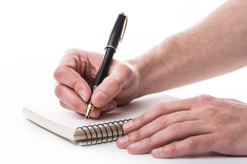 Man writing a note with black ball pen in his hand, isolated